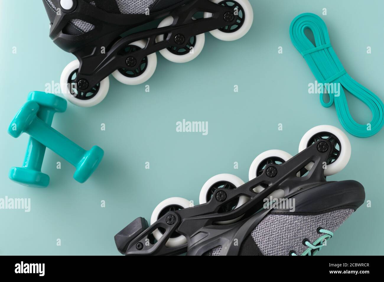 Active lifestyle and fitness border with hand weights, roller skates, and resistance band on a