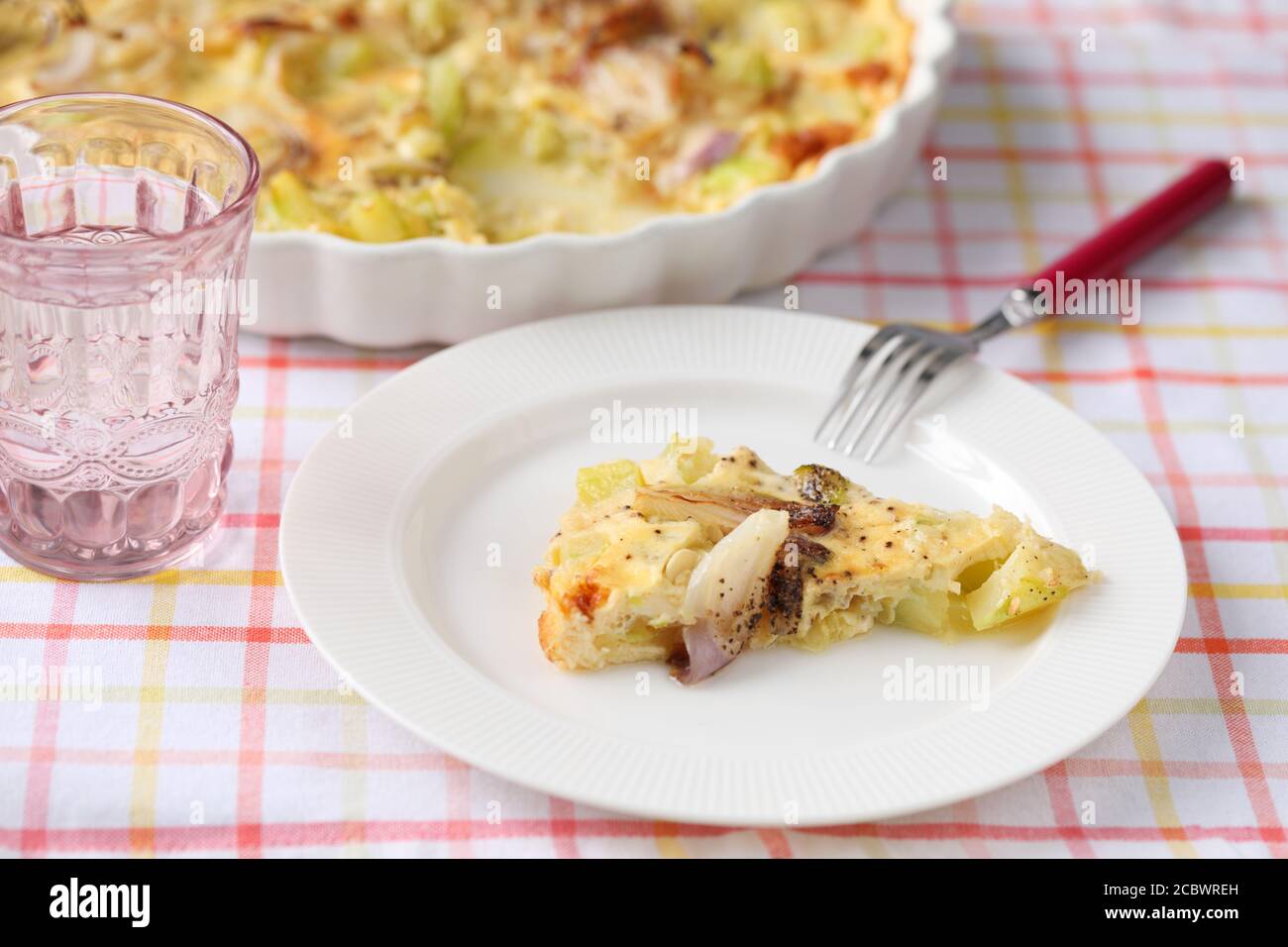 Slice of backed summer squash and onion omelet on a plate Stock Photo