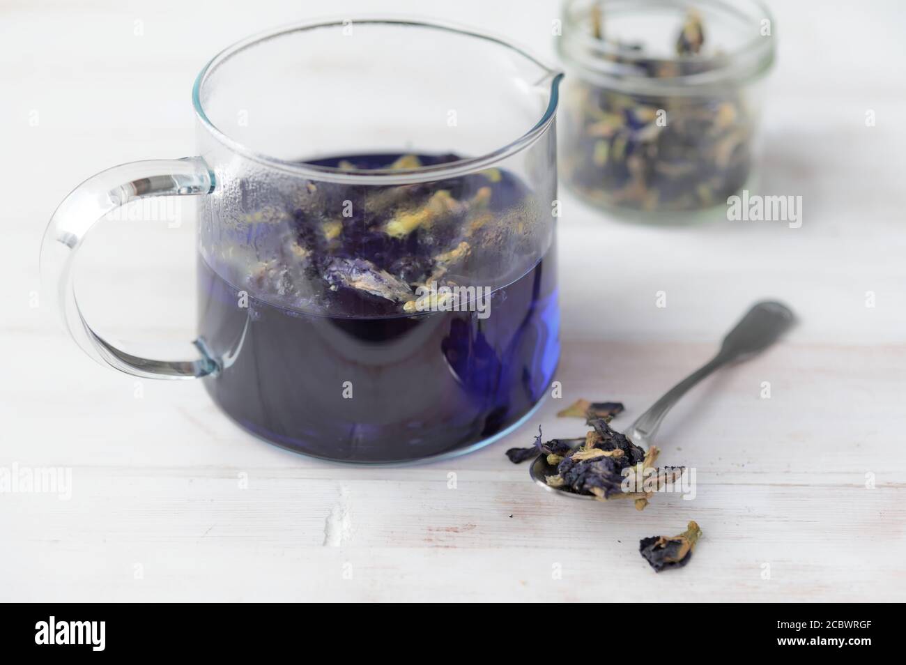Preparing blue tea in a glass pot Stock Photo
