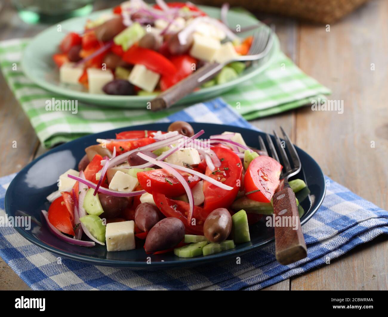 Two portions of Greek salad on a rustic table Stock Photo