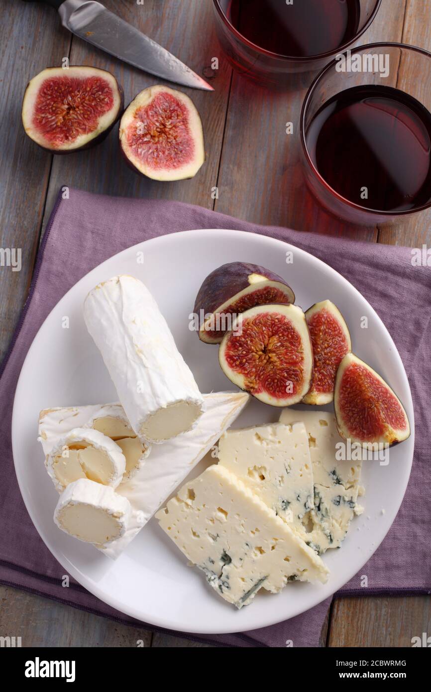 Cheese plate, figs, and red wine Stock Photo