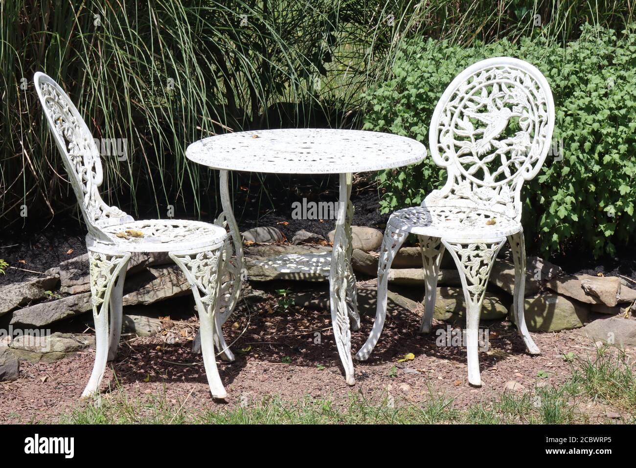 The wrought iron table and chairs by the gsrden Stock Photo Alamy