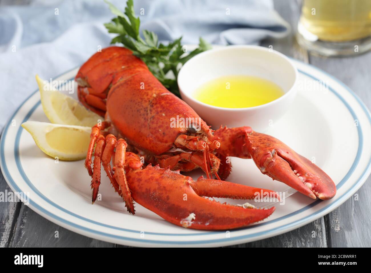 Lobster on plate with lemon and parsley Stock Photo