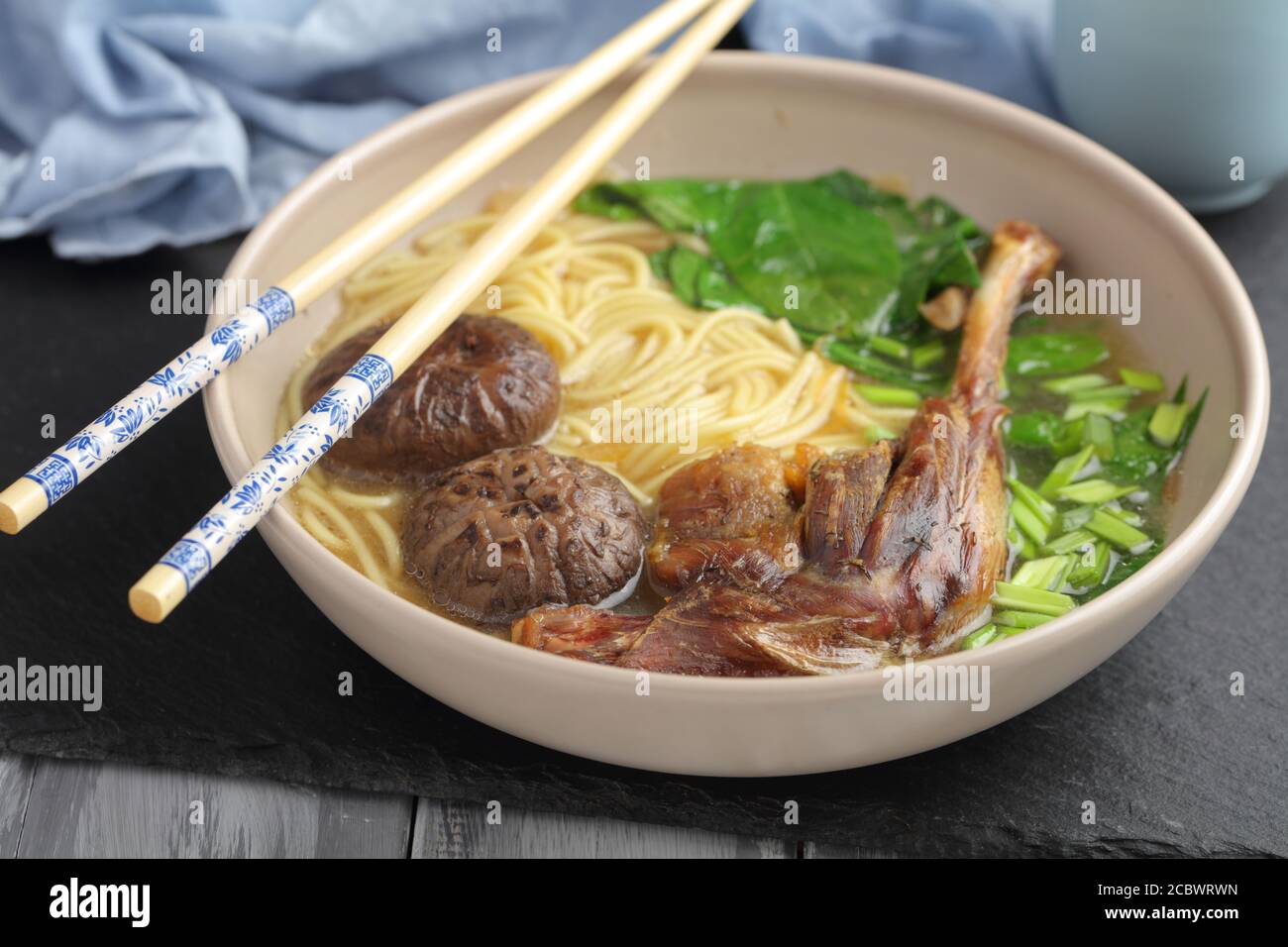 Chinese duck noodle soup with shiitake mushrooms, spinach, and egg