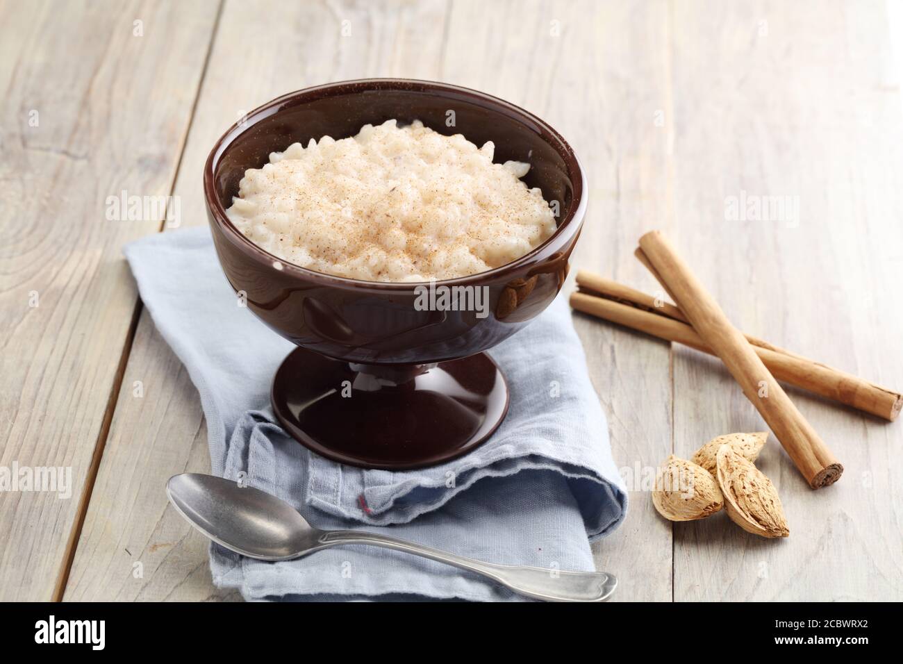 Rice pudding topped with cinnamon powder and almonds Stock Photo