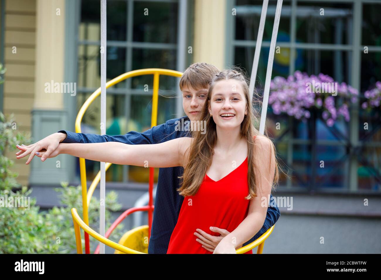 young couple resting on a swing in a summer park. romantic meeting Stock Photo