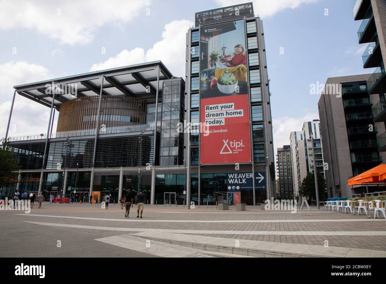 Brent Civic Centre, as seen from the east side. Shops and a library are featured at the ground level. An advert can be seen for renting local housing. Stock Photo