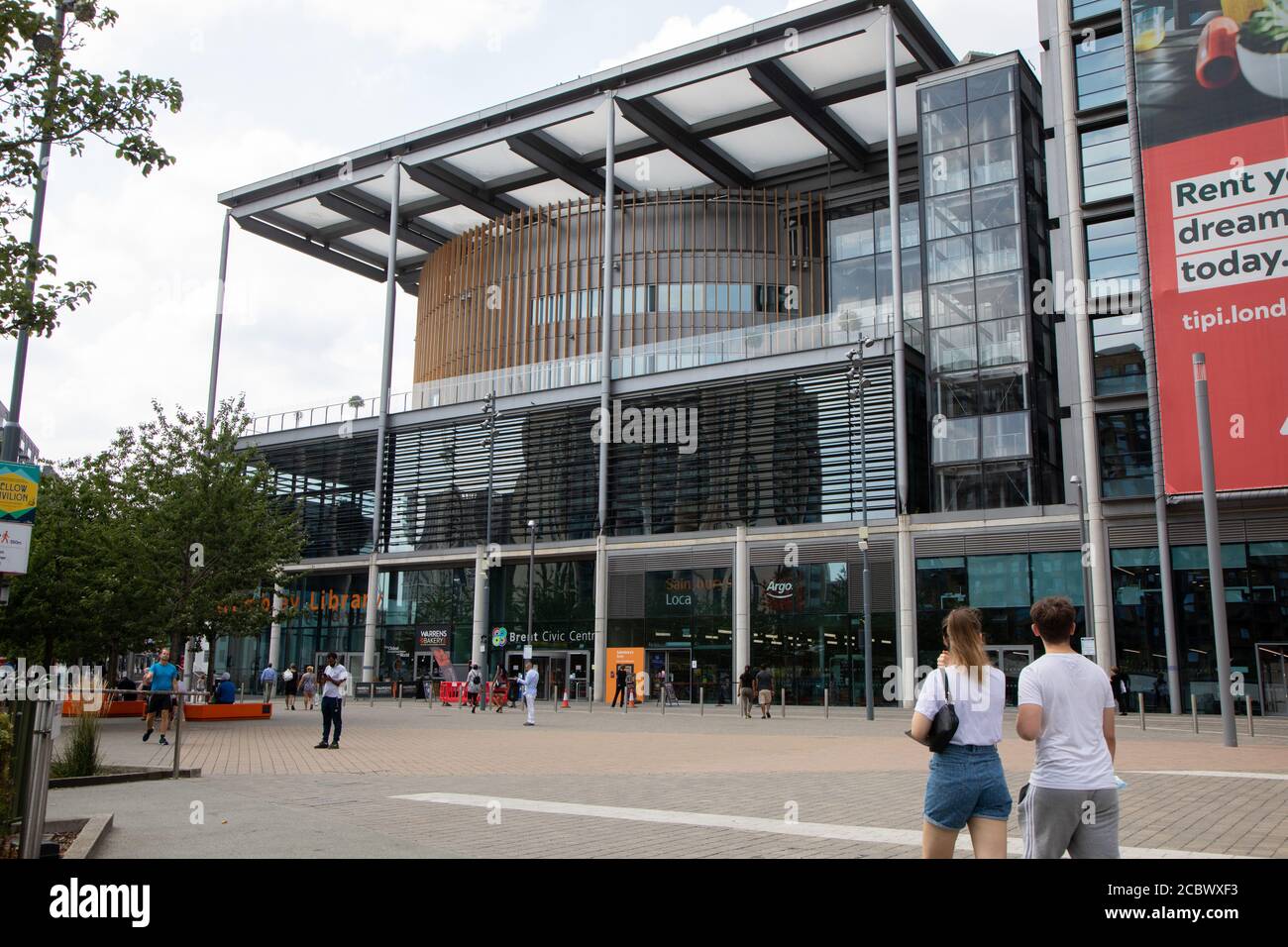 Brent Civic Centre, as seen from the east side. Shops and a library are featured at the ground level. An advert can be seen for renting local housing. Stock Photo
