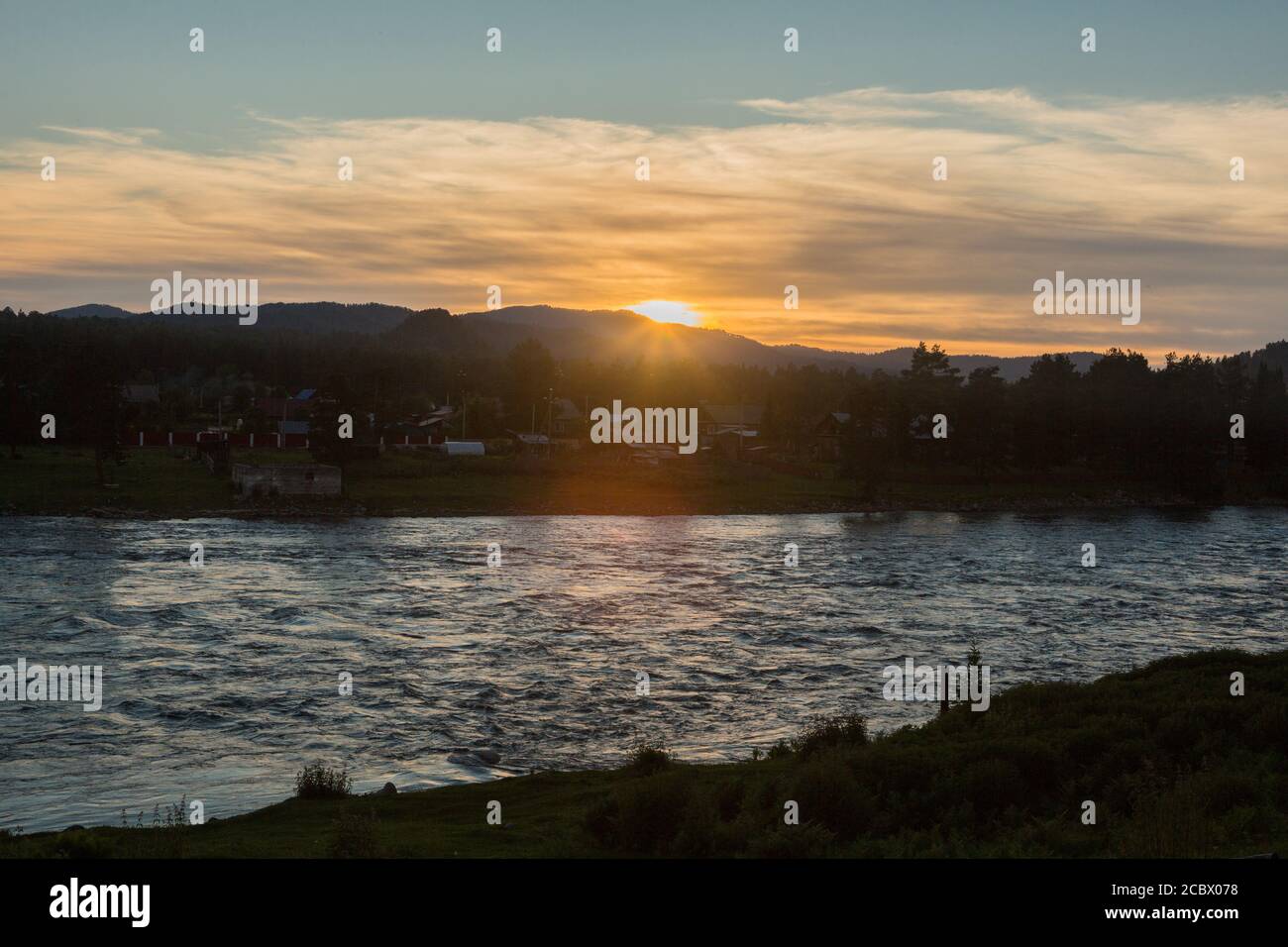 Sunset on a choppy river wind early spring landscape Stock Photo