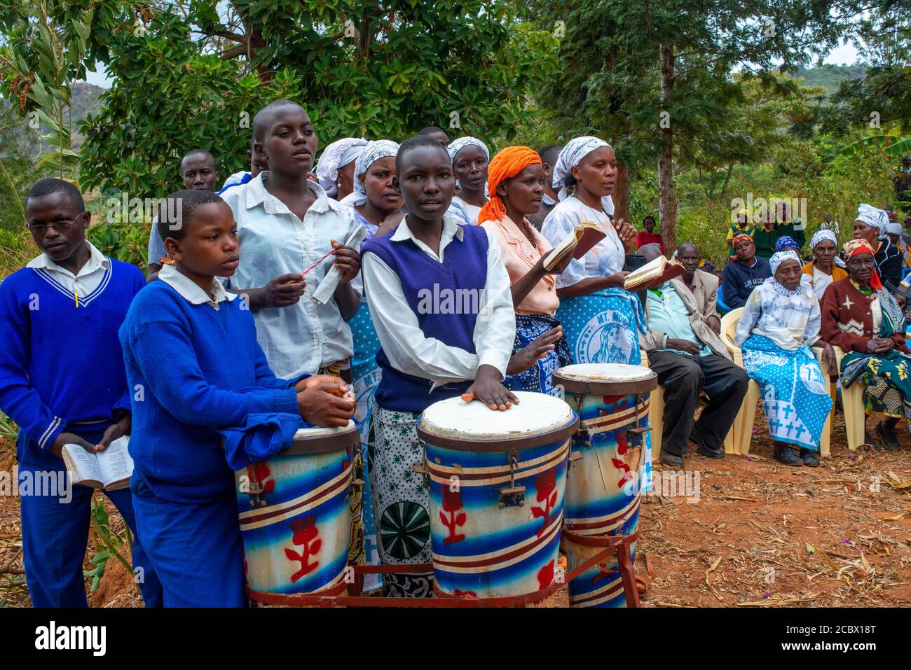 Playing drums in a funeral for the death of a person due to Coronavirus and AIDS in a small village near Kitui city in the Kamba country in Kenya, Afr Stock Photo