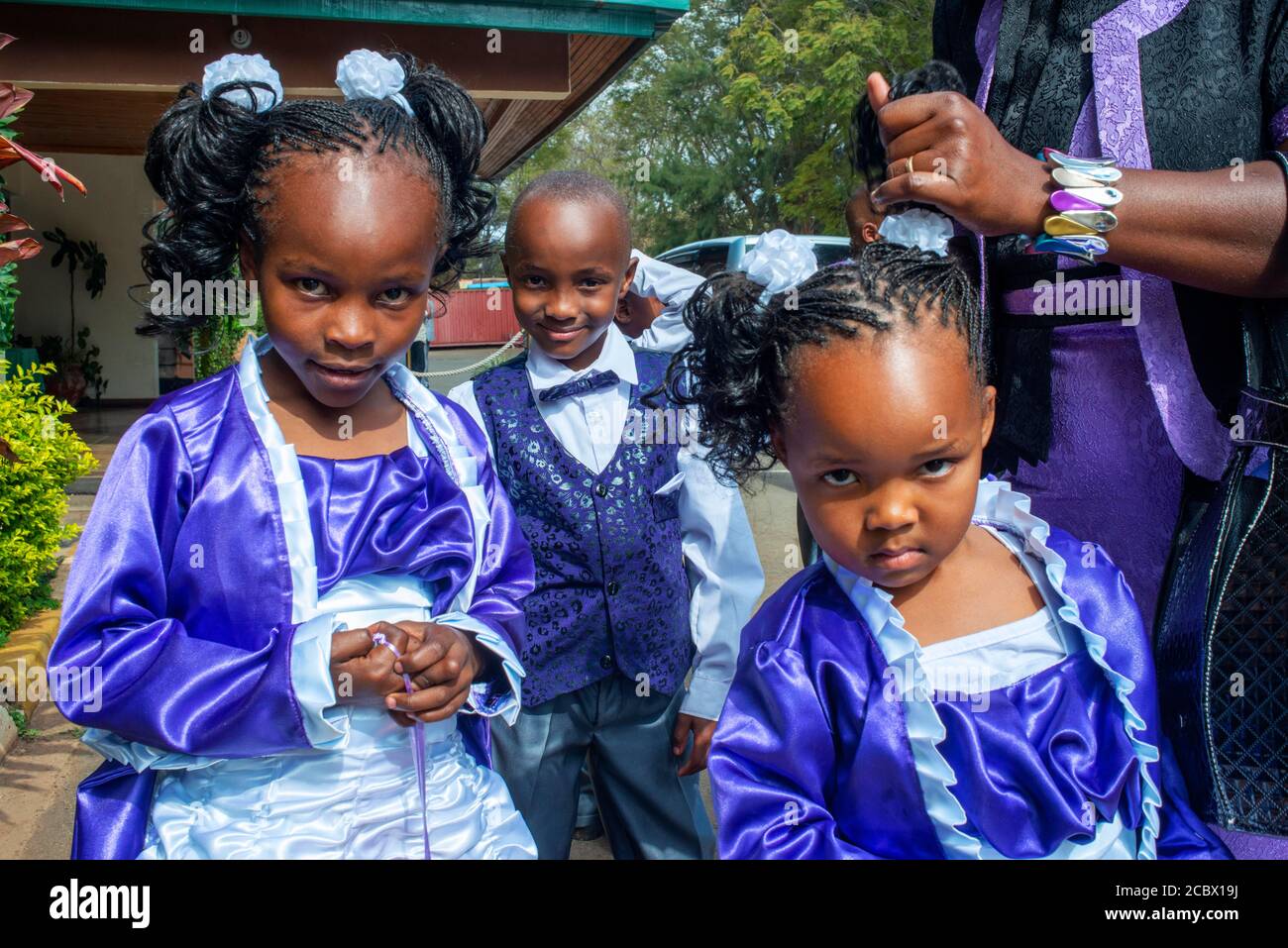 Rich family dressed to go to Christian sunday mass in a small village near Kitui in the Kamba country in Kenya, Africa. Stock Photo
