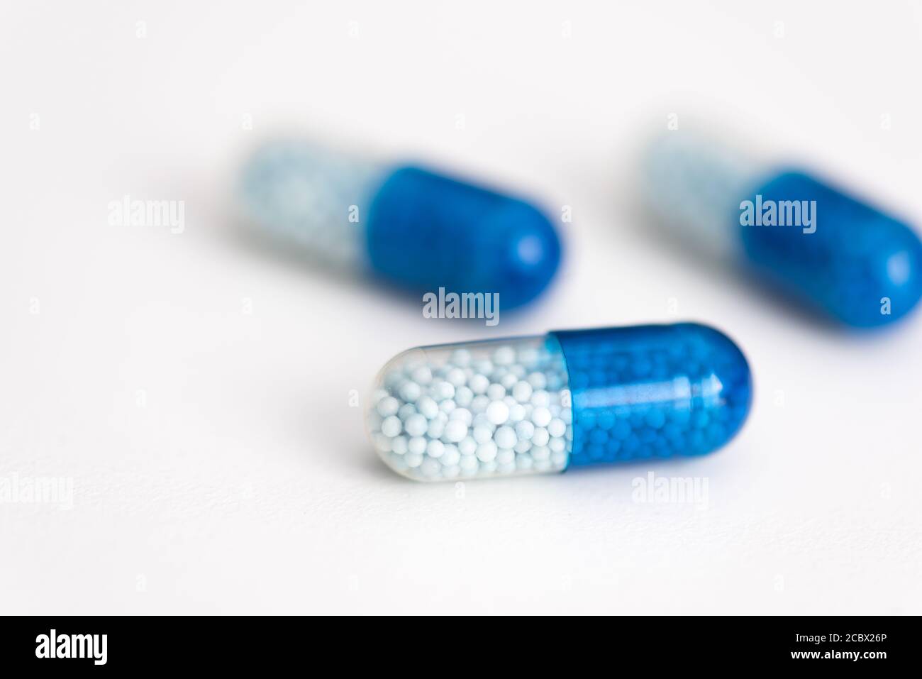 Blue capsule, pills on white background. Health care, medical, pharmacy concept Stock Photo