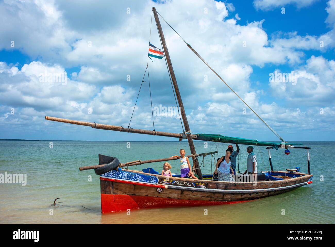 Tourists european family inside a dhow sailing boat in Manda island in