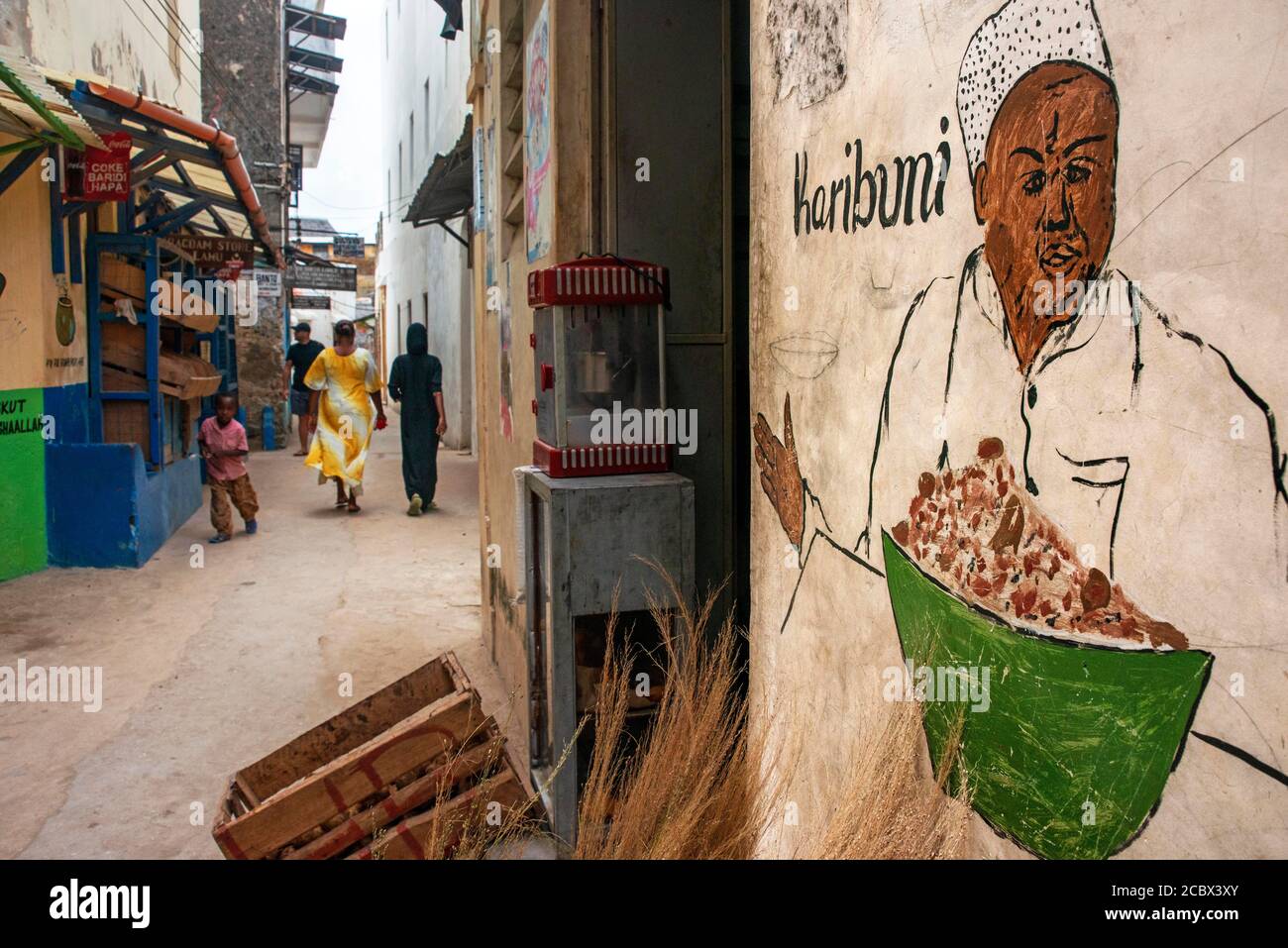 Local people in the narrow strees of the city town of Lamu island in Kenya Stock Photo