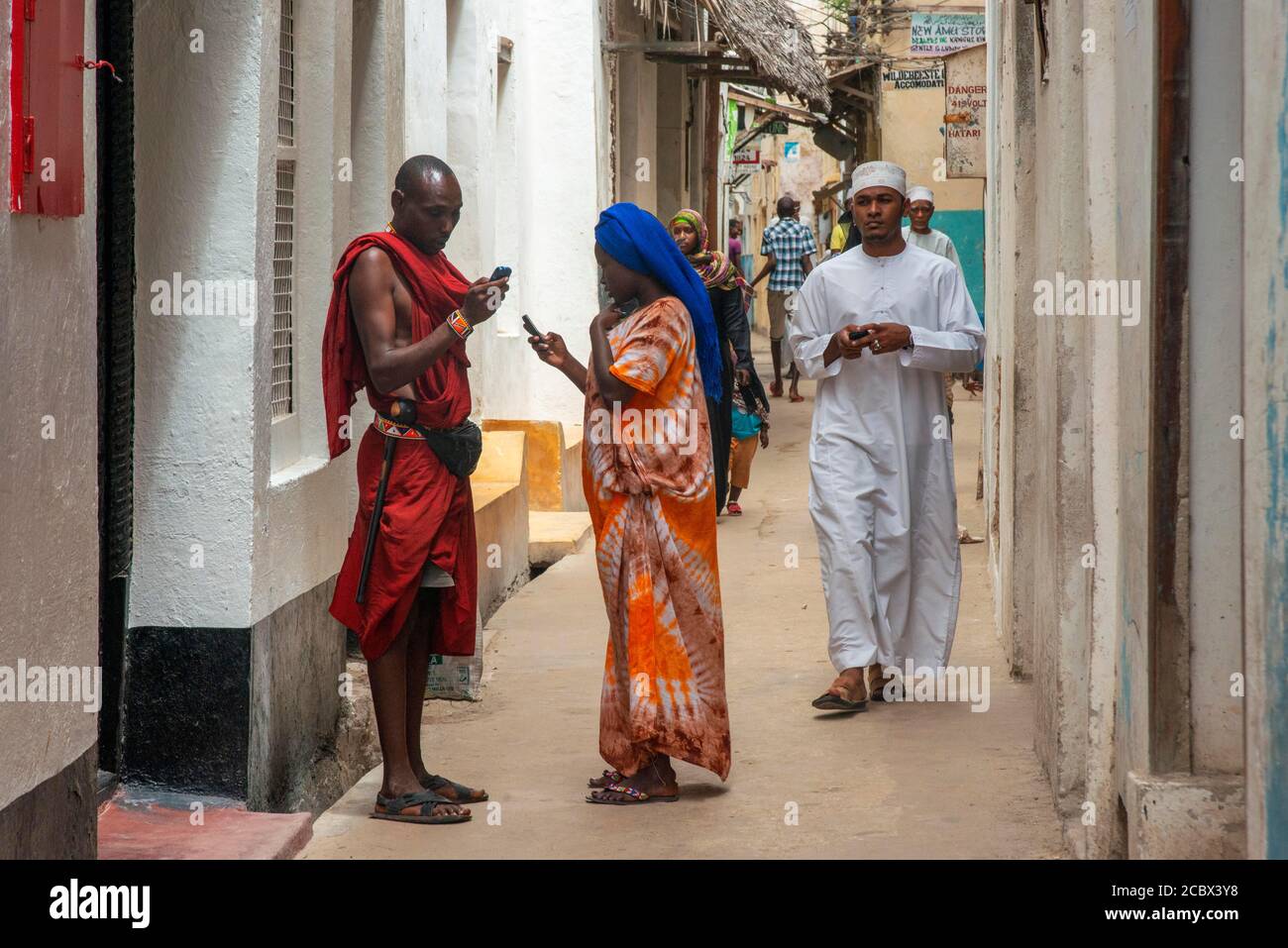 Local people in the narrow strees of the city town of Lamu island in Kenya Stock Photo