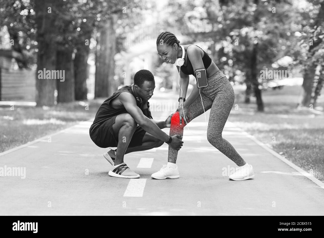 Knee Injury. Black woman suffering from trauma during jogging with