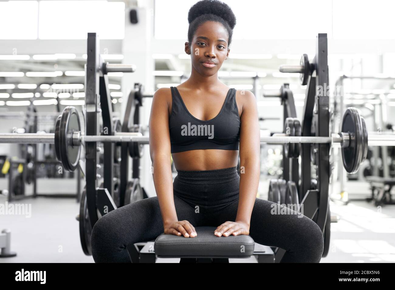 african woman having rest,have fitness day in the gym. beautiful lady in  sportswear sit looking at camera, alone Stock Photo - Alamy