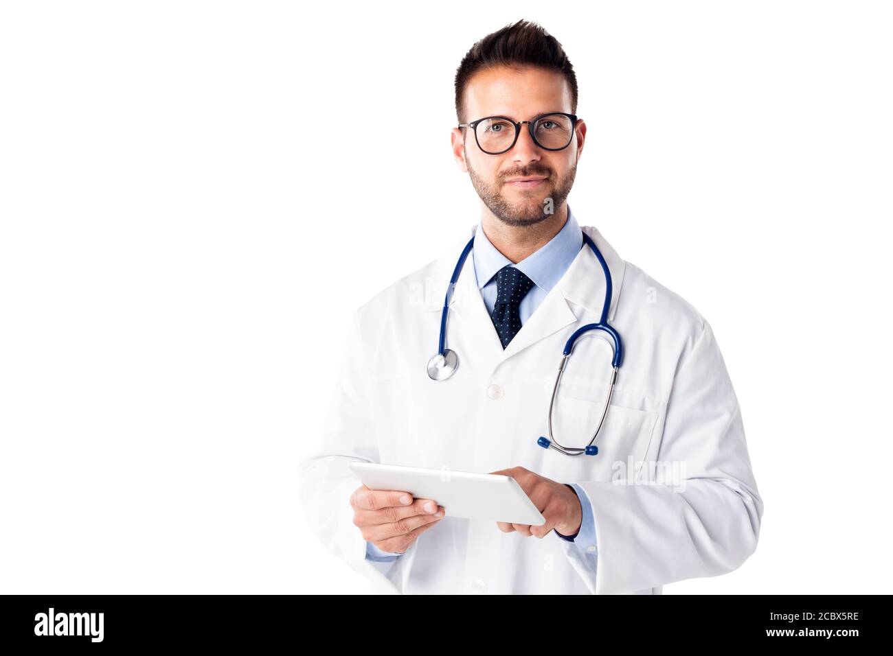 Studio shot of male doctor holding digital tablet in his hand while standing at isolated white background. Copy space. Stock Photo