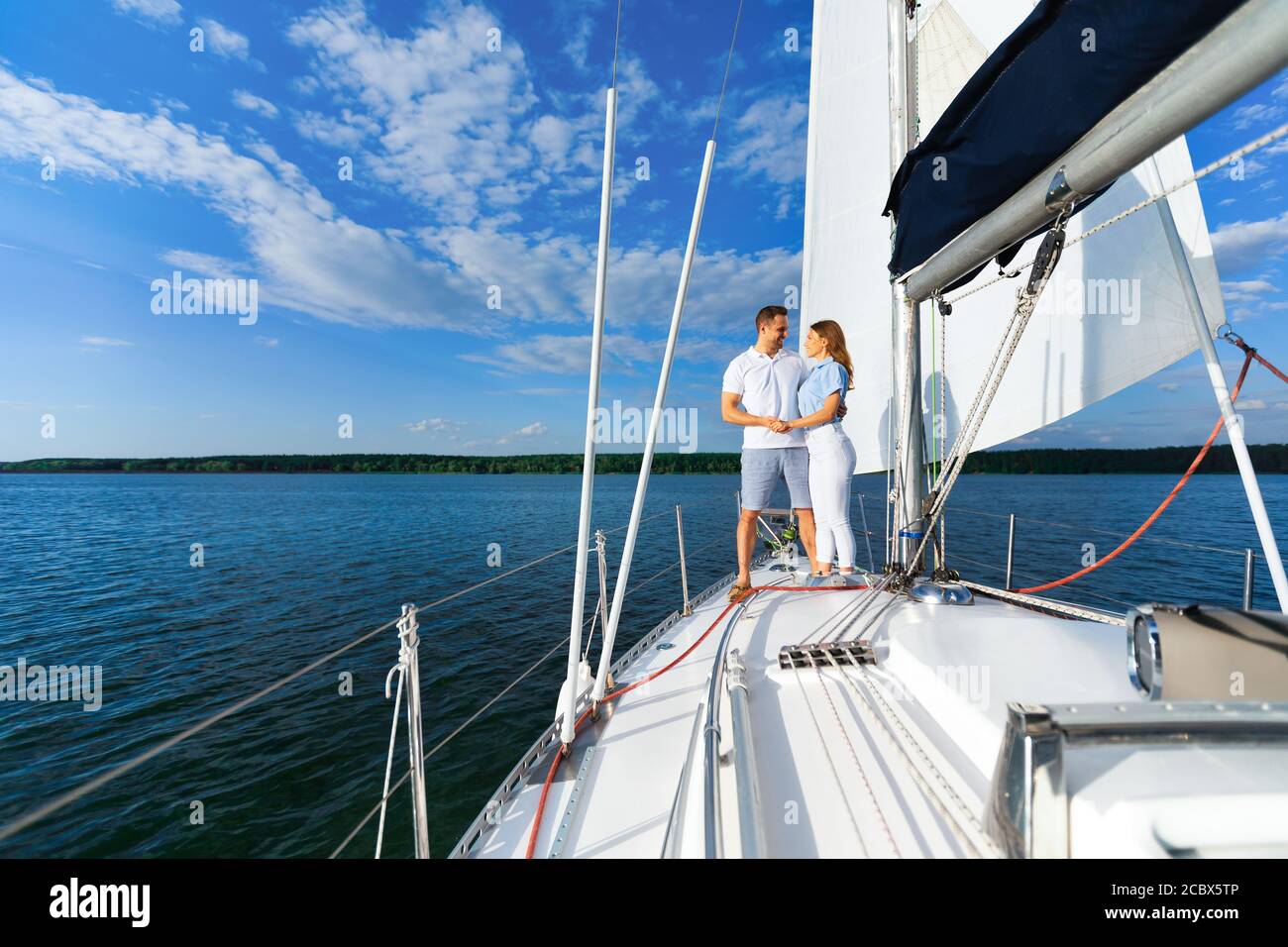 Couple Dating On Yacht, Hugging Standing On Deck Outside Stock Photo