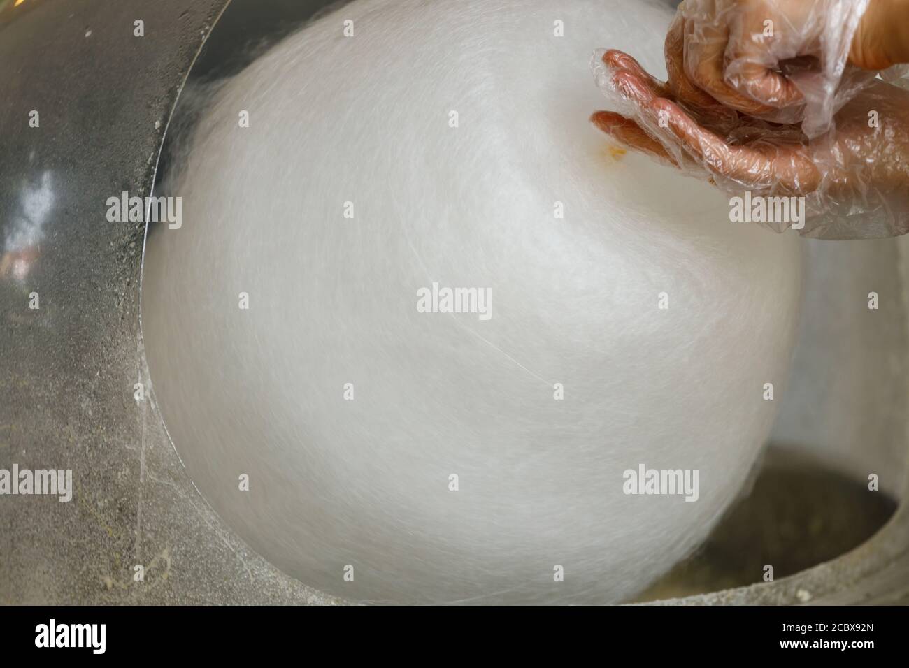 hand with cotton candy. manufacturing process Stock Photo Alamy
