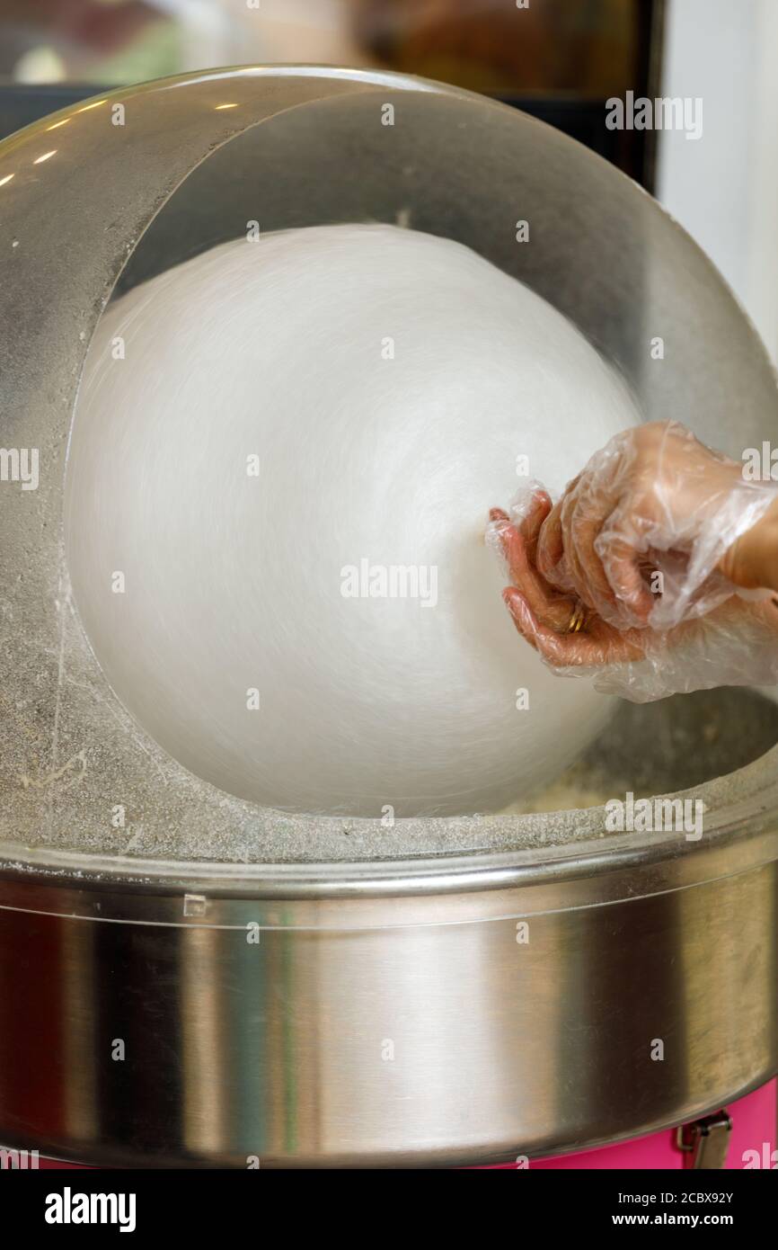 hand with cotton candy. manufacturing process Stock Photo Alamy