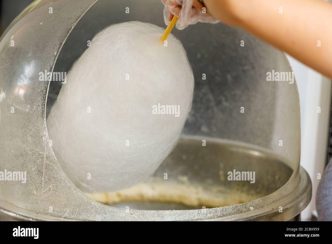 hand with cotton candy. manufacturing process Stock Photo Alamy