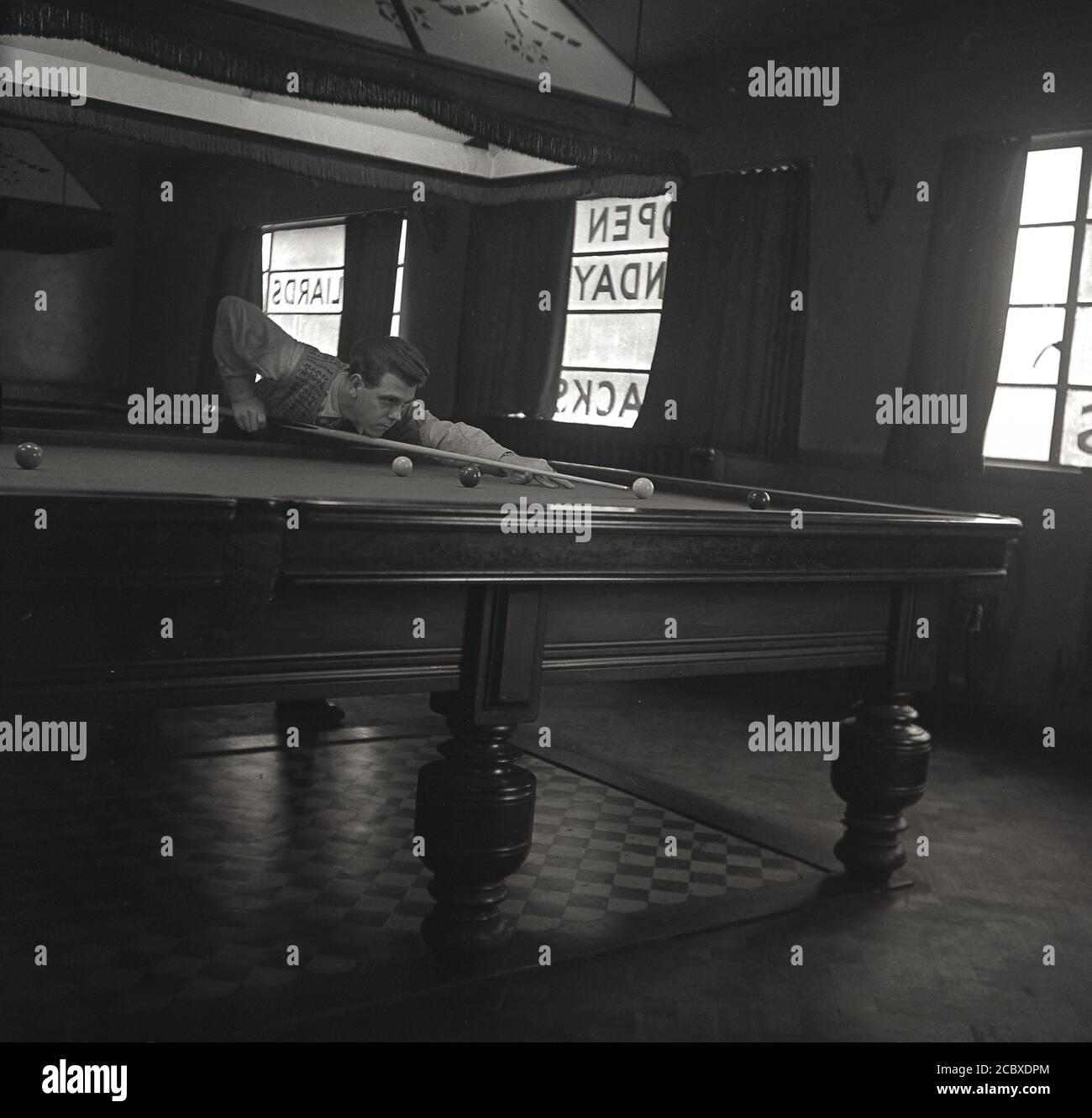 1950s, historical, a man playing snooker, leaning on a fullsized