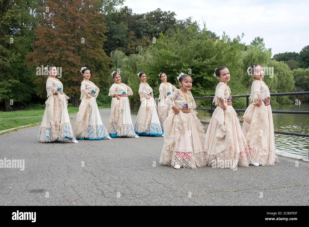 A small group of Paraguayan American folk dancers in native costumes pose for photos. In a park in Flushing, Queens, New York City. Stock Photo