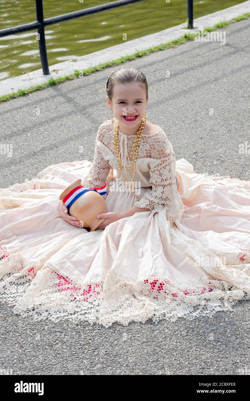 Posed portrait of a young member of a Paraguayan American folk dance group. In a park in Flushing, Queens, New York City. Stock Photo