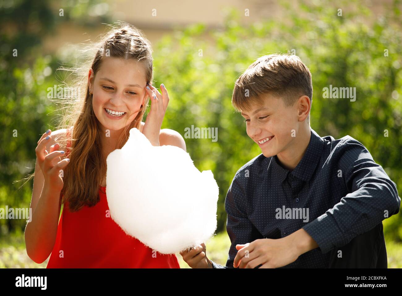 young couple on a romantic date eats cotton candy. Stock Photo