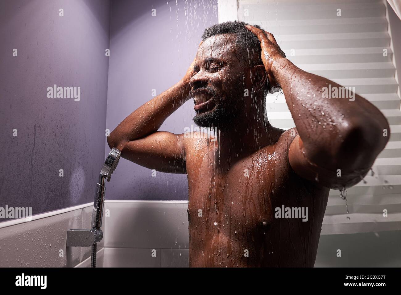 athletic african sportsman take shower after sport workout, fitness. wash away sweat and