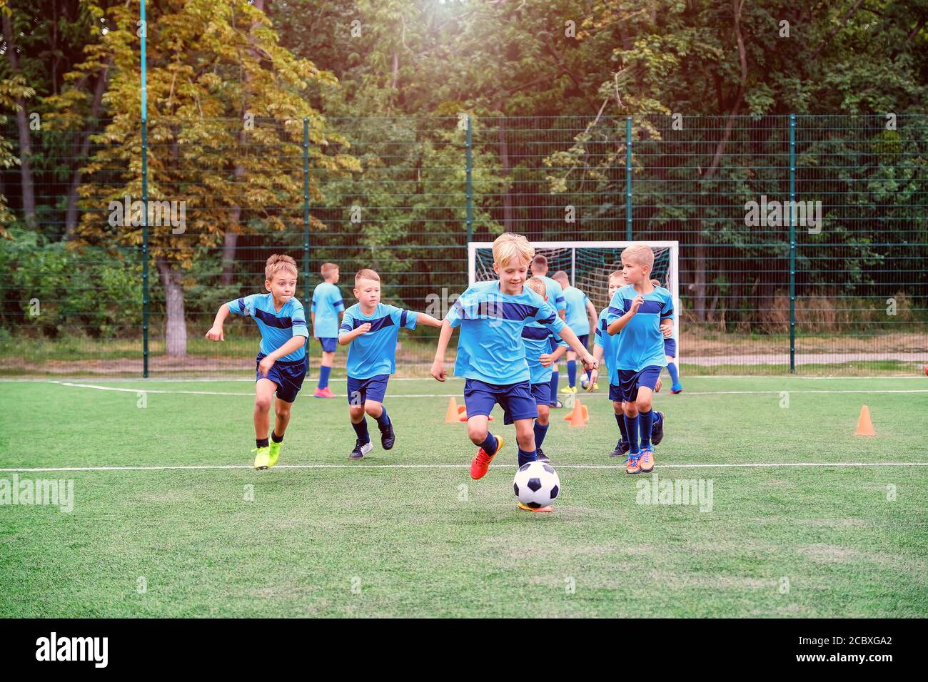 Boy running with football hi-res stock photography and images - Alamy