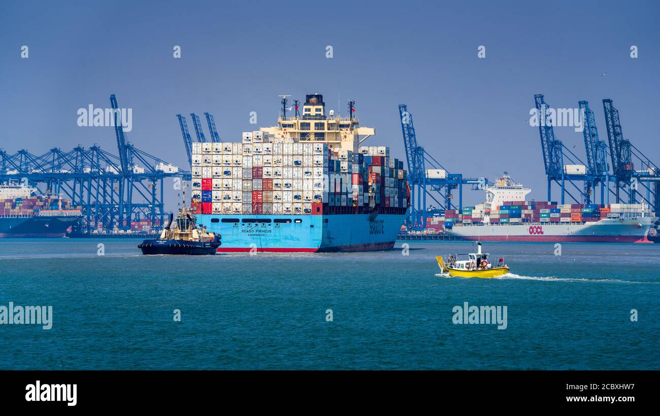 Seago Line Container Ship enters Felixstowe Port UK - the Seago Piraeus Container Vessel manoeuvres into Felixstowe ahead of the Harwich Harbour Ferry. Stock Photo