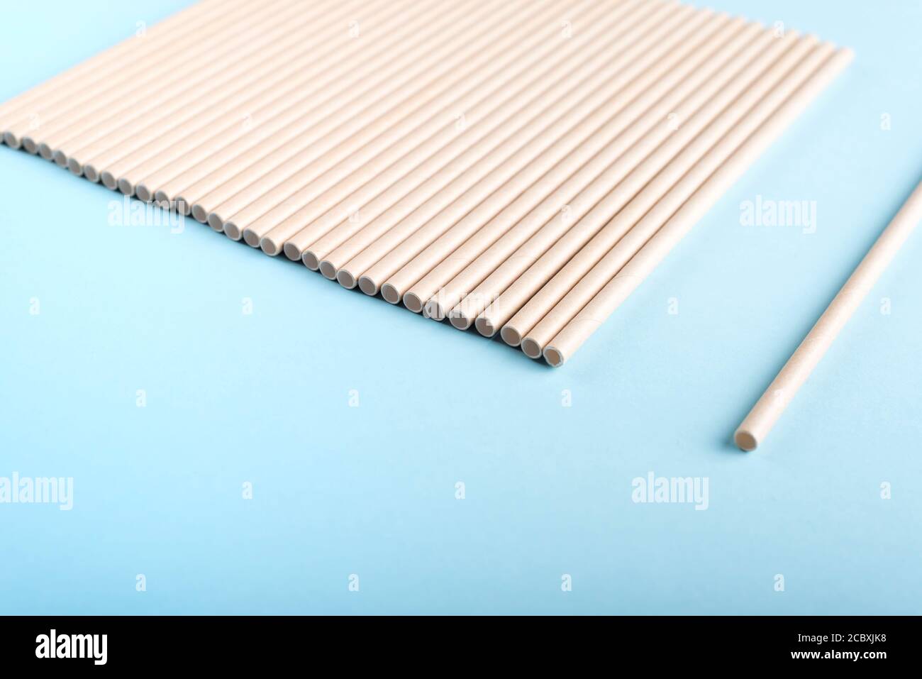 Paper drinking straws on light blue background. Stock Photo