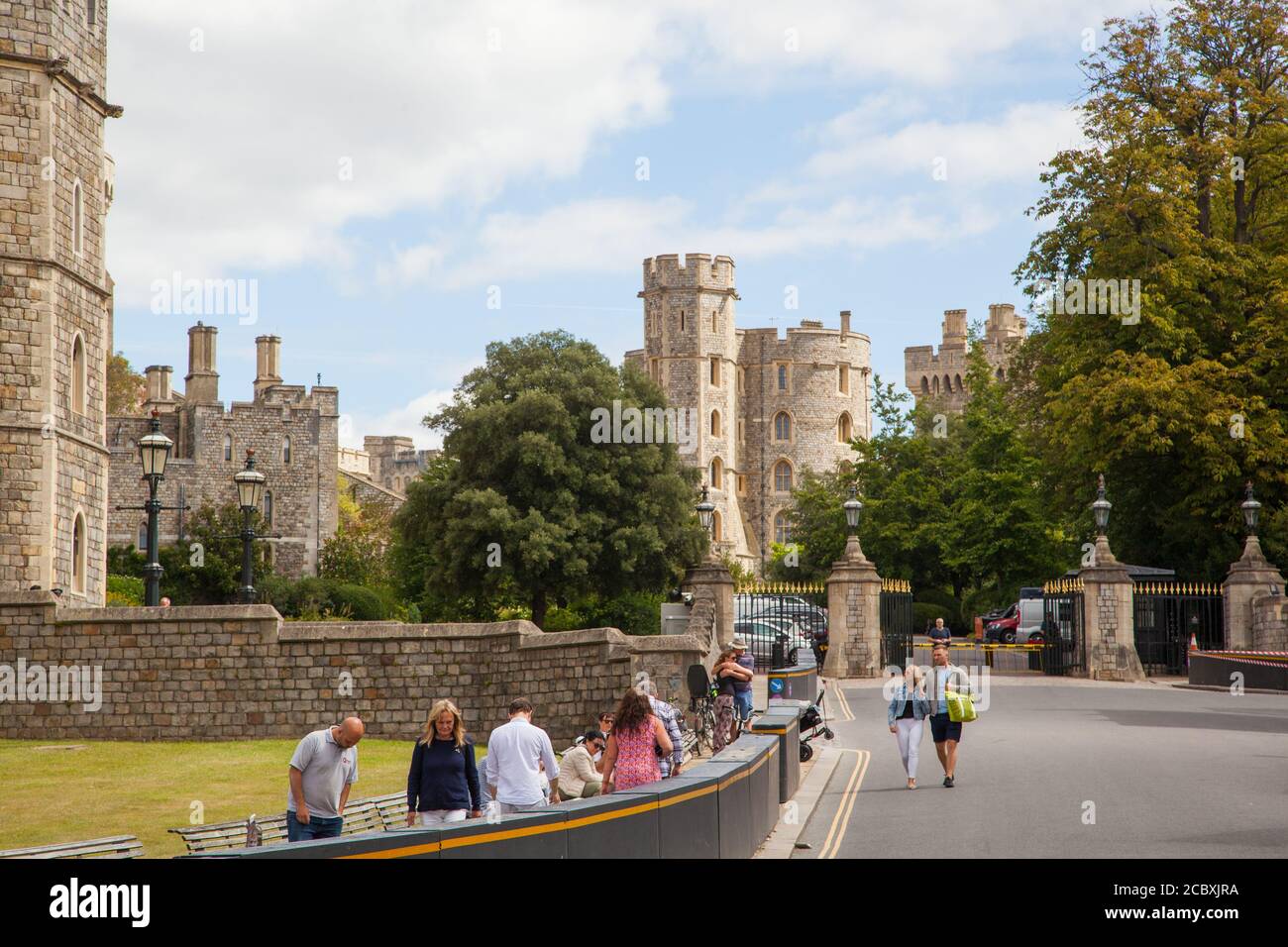 Tourists visitors and day tippers take in the view of Windsor Castle England UK Stock Photo