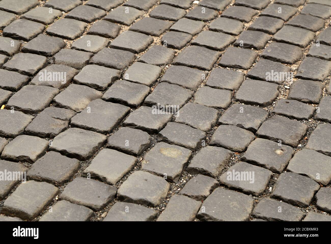Abstract background of old cobblestone pavement close-up Stock Photo