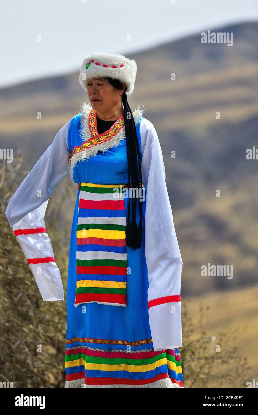Yugur woman-ethnic attire-terai hat-traditional dancing and singing. MatiSi complex-Zhangye-Gansu-China-1013 Stock Photo