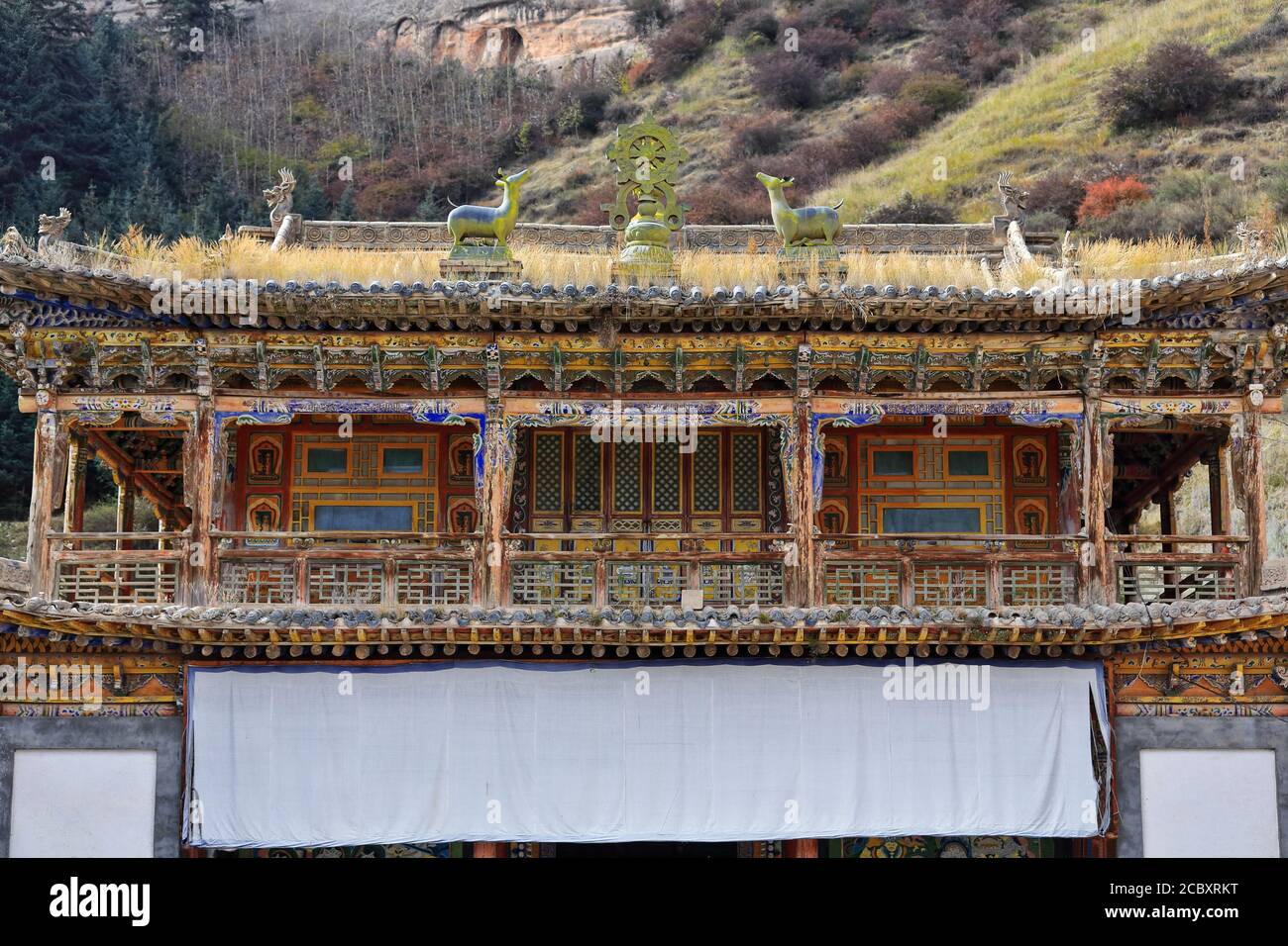 Woodcarved-polychrome loggia-ashtamangala Buddhist symbols-Shengguo Temple. MatiSi-Horse Hoof Temple-Sunan Yugur county-Zhangye-Gansu-China-1019 Stock Photo