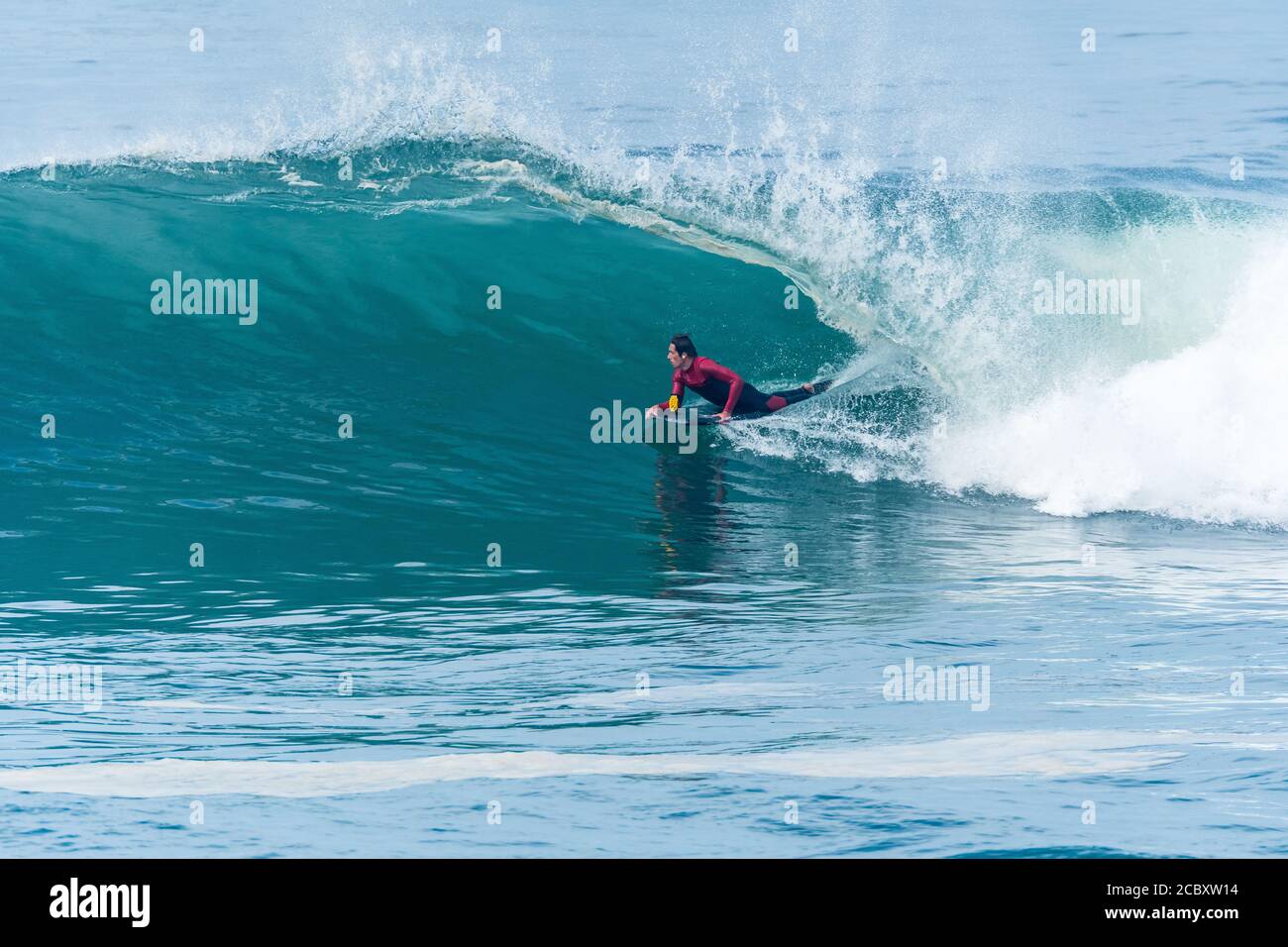 Bodyboarder surfing ocean wave on a sunny day Stock Photo - Alamy