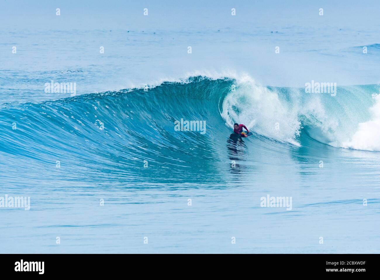 Bodyboarder surfing ocean wave on a sunny day Stock Photo - Alamy