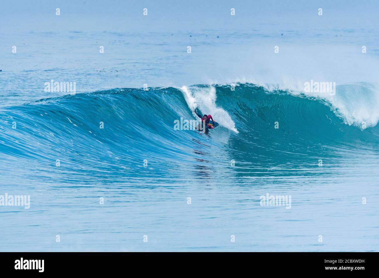 Bodyboarder surfing ocean wave on a sunny day Stock Photo - Alamy