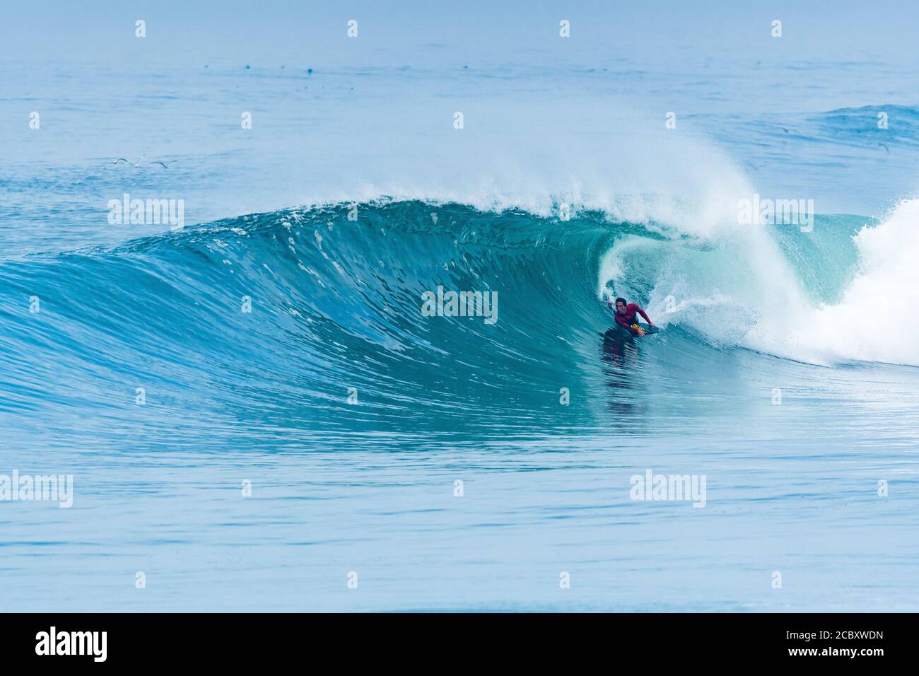 Bodyboarder surfing ocean wave on a sunny day Stock Photo - Alamy