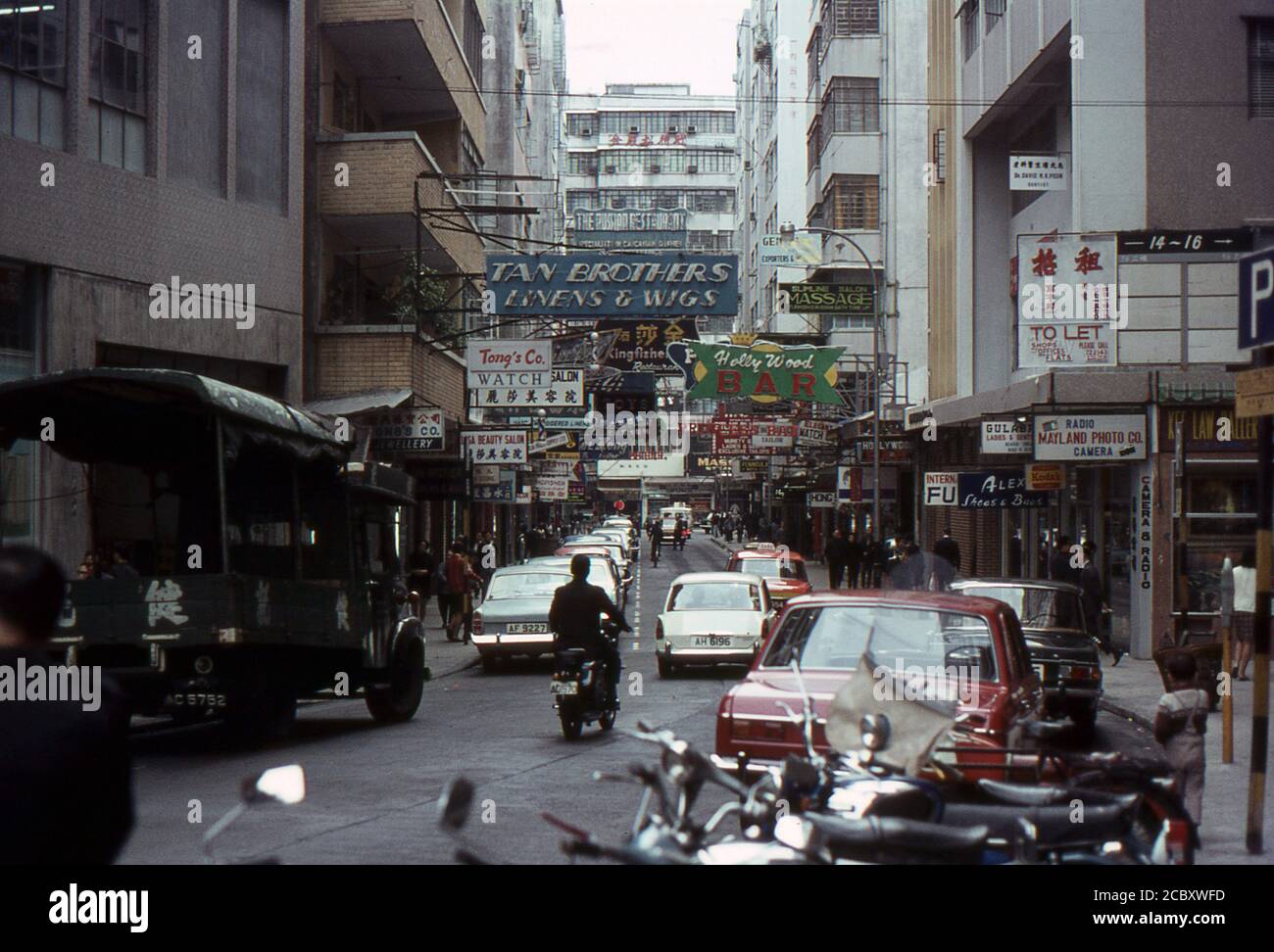 A busy street scene in Hong Kong. 1968. Humphreys Avenue, Kowloon. Advertising signs on buildings. Stock Photo