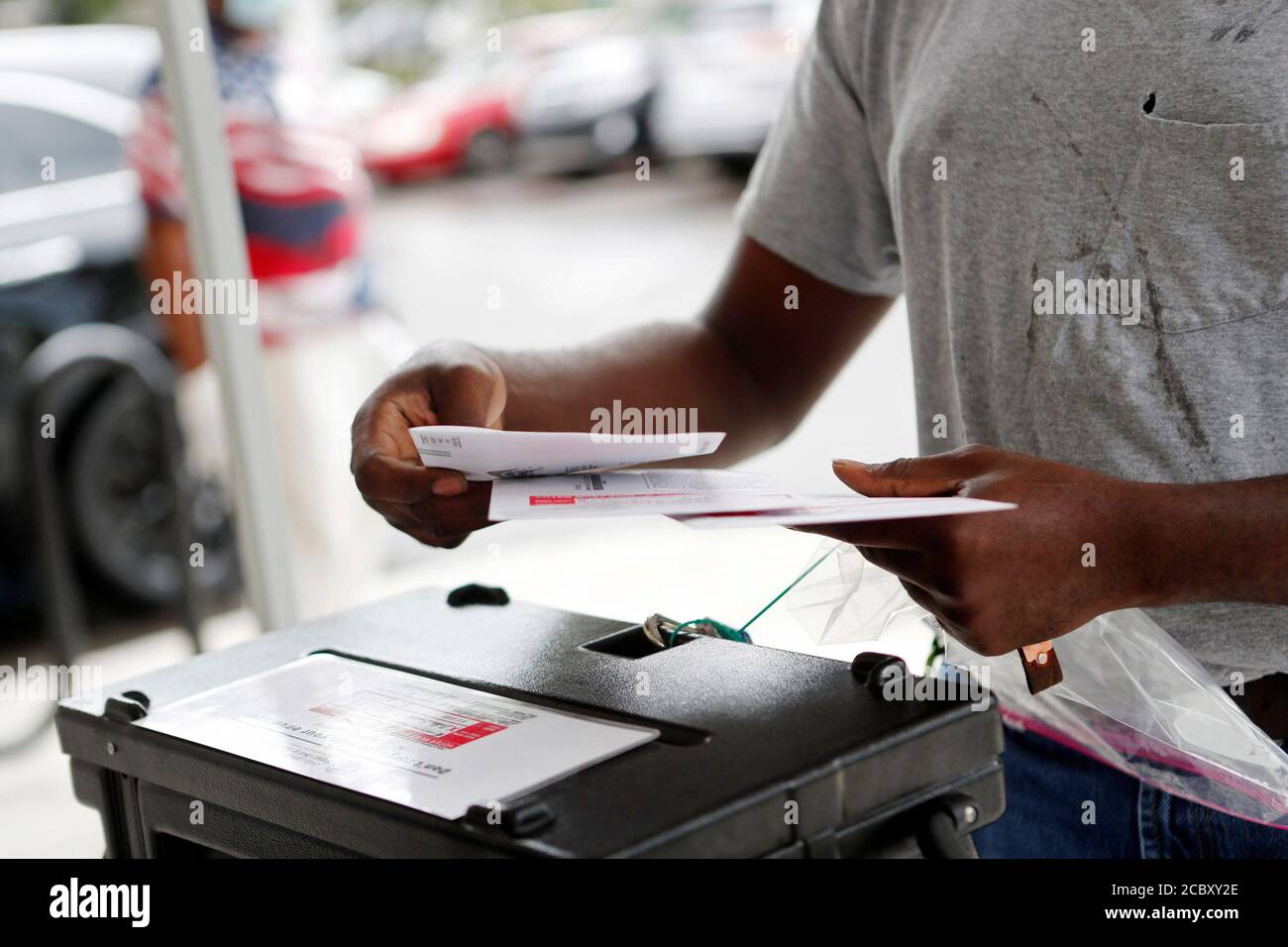 Maurice Jones prepares to cast mail-in voting ballots for his family on the last day of early voting for the U.S. presidential election at the C. Blythe Andrews, Jr. Public Library in East Tampa, Florida, U.S., August 16, 2020.  REUTERS/Octavio Jones Stock Photo