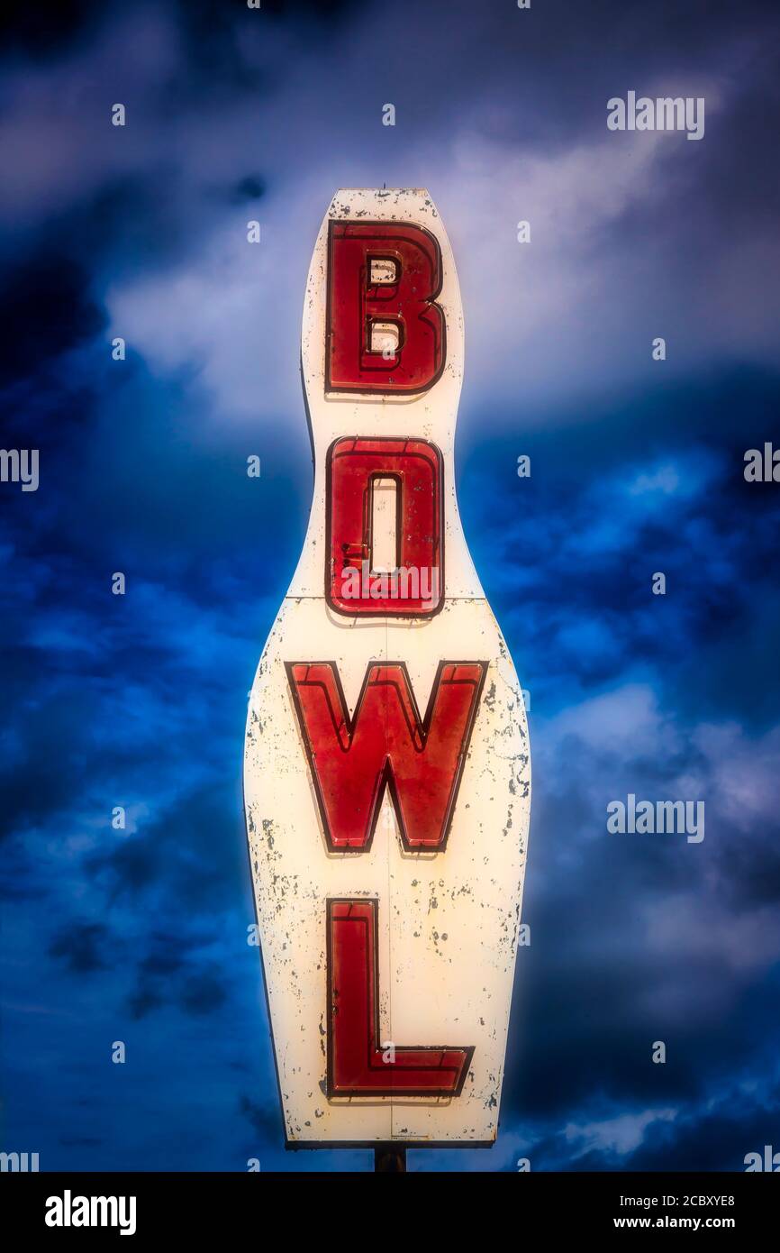 Old Bowling Alley Sign Against Stormy Clouds Stock Photo