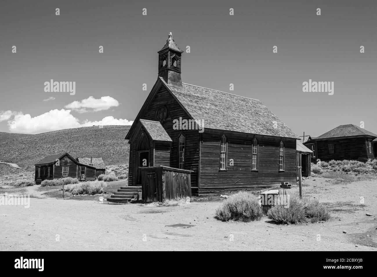 Black and white view of wild west ghost town church and other buildings at Bodie State Historic park in California. Stock Photo