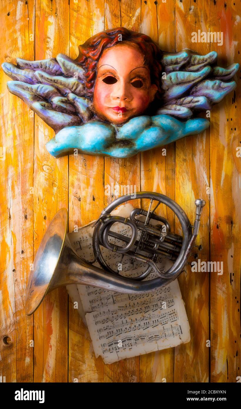 Angel Mask With French Horn And Sheet Music Stock Photo