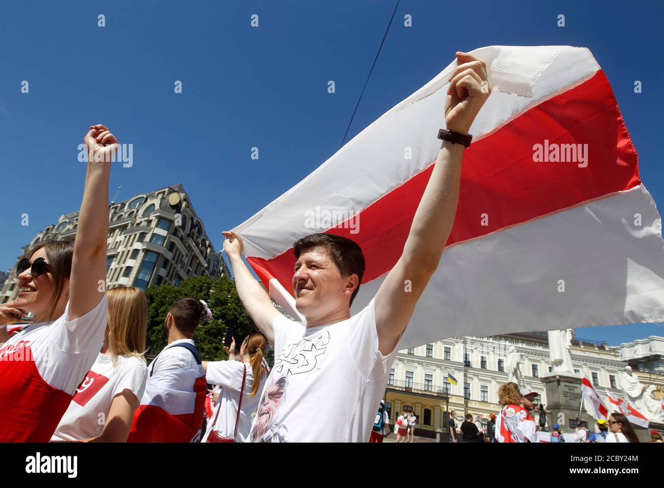 A protester holding the historic Belarusian flag during the demonstration.Belarusian citizens living in Ukraine and activists took part in a rally called 'March for Free Belarus' protesting against rigging Belarus presidential election. Stock Photo