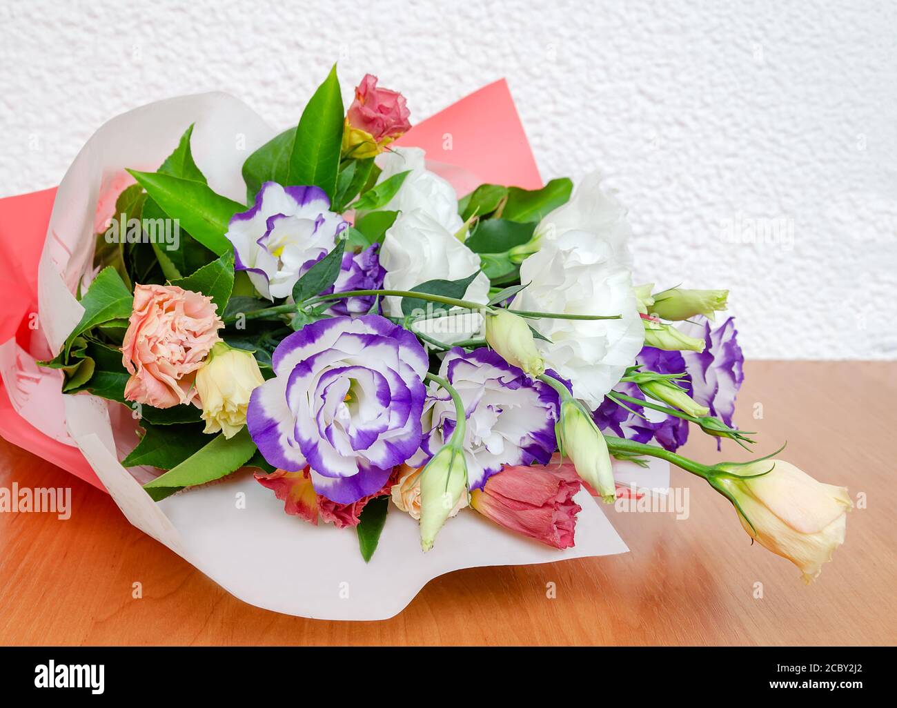 eustoma natural bright flower in a bouquet, a gift for the holiday on the table, close-up Stock Photo