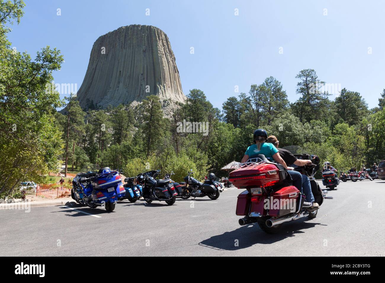 A throng of motorcycles crowd the parking lot at Wyoming's Devils Tower National Monument on Friday, August 14, 2020. Every year, bikers who attend the nearby Sturgis Motorcycle Rally in South Dakota descend on the iconic landmark. Stock Photo